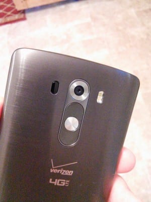 The backplate of the LG G3, displaying the volume keys, power button at the center, and camera.