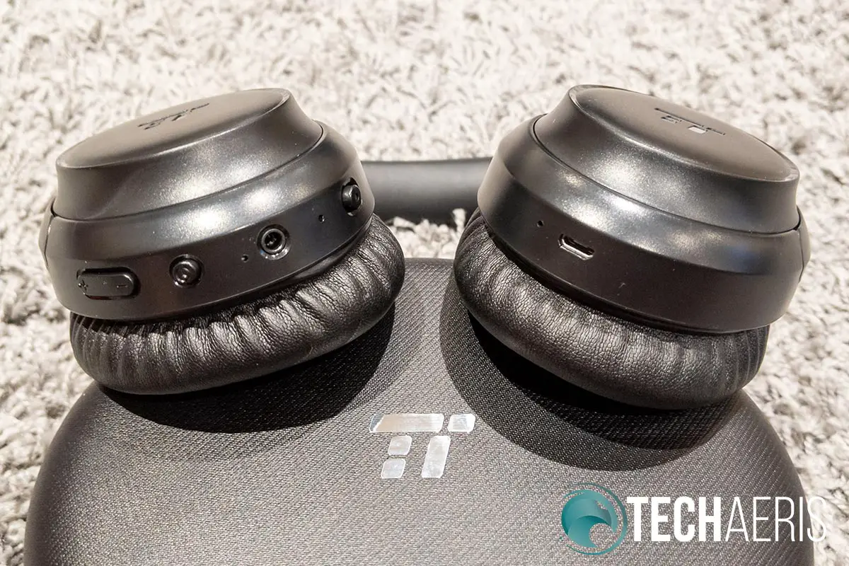 The controls and ports on the bottom of the TaoTronics SoundSurge 60 Active Noise Cancelling Wireless Stereo Headphones earcups