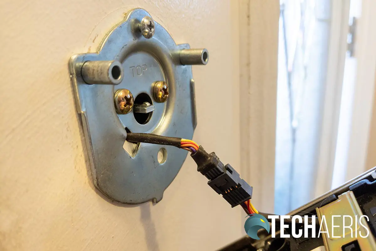 The cable connecting the touchscreen and inside assemblies on the Schlage Encode Smart Wi-Fi Deadbolt