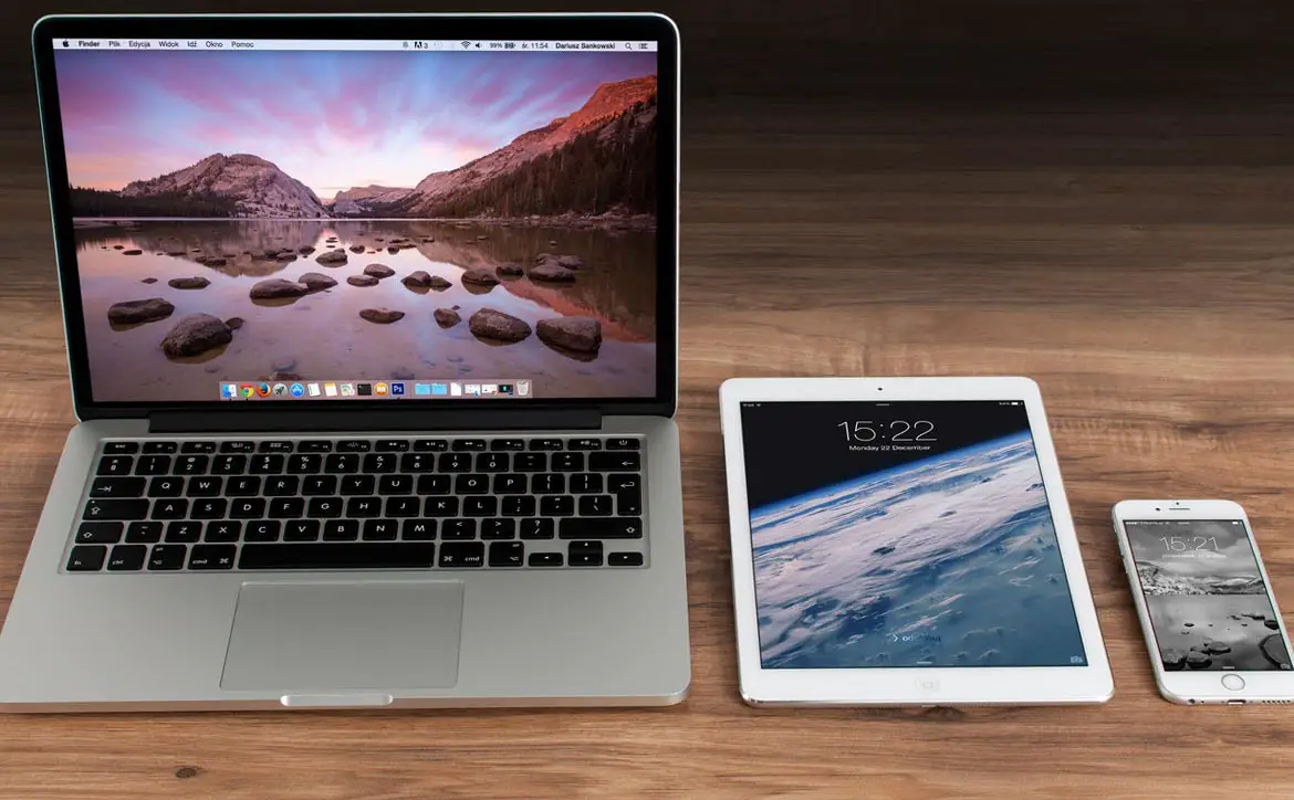 Apple Macbook computer, iPad tablet, and iPhone