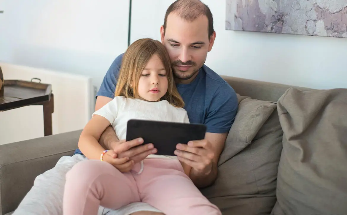 Parental controls in the digital age rely on APIs man with child on tablet