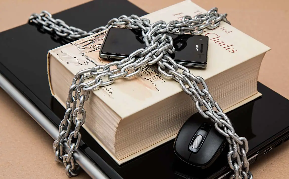 secure information smartphone laptop book with chains around them