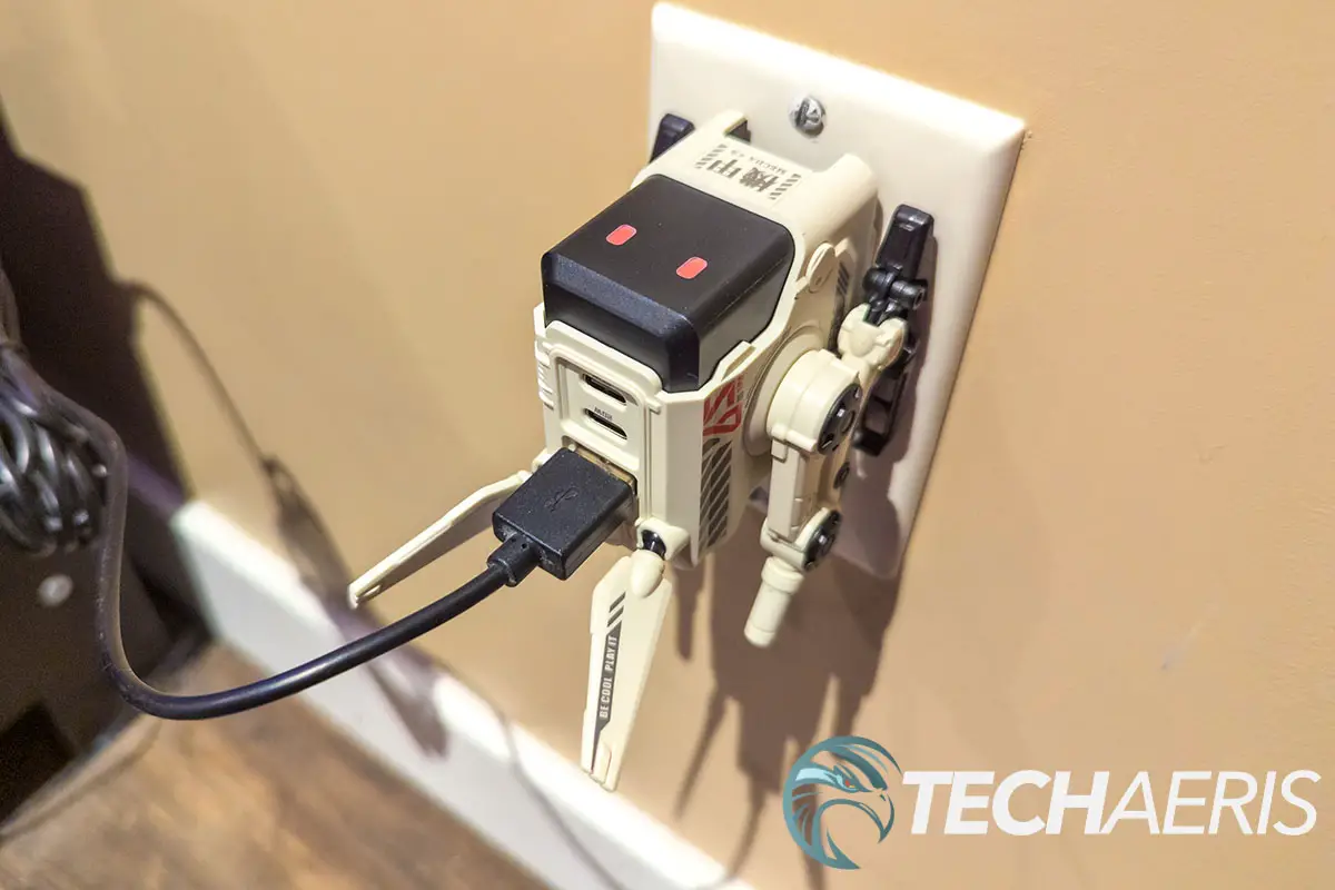 The GravaStar Alpha65 65W GaN Charger plugged into a wall outlet