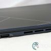The USB port and ventilation cutouts on the left edge of the ASUS Zenbook 14 OLED laptop